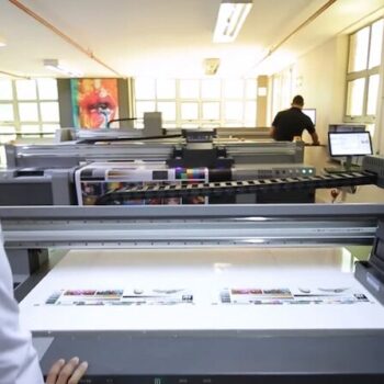 Digital printing ink manufacturing facility with large inkjet printers, related to NUtec Digital Ink's expertise in digital printing inks, located in an industrial space on the About Us page.