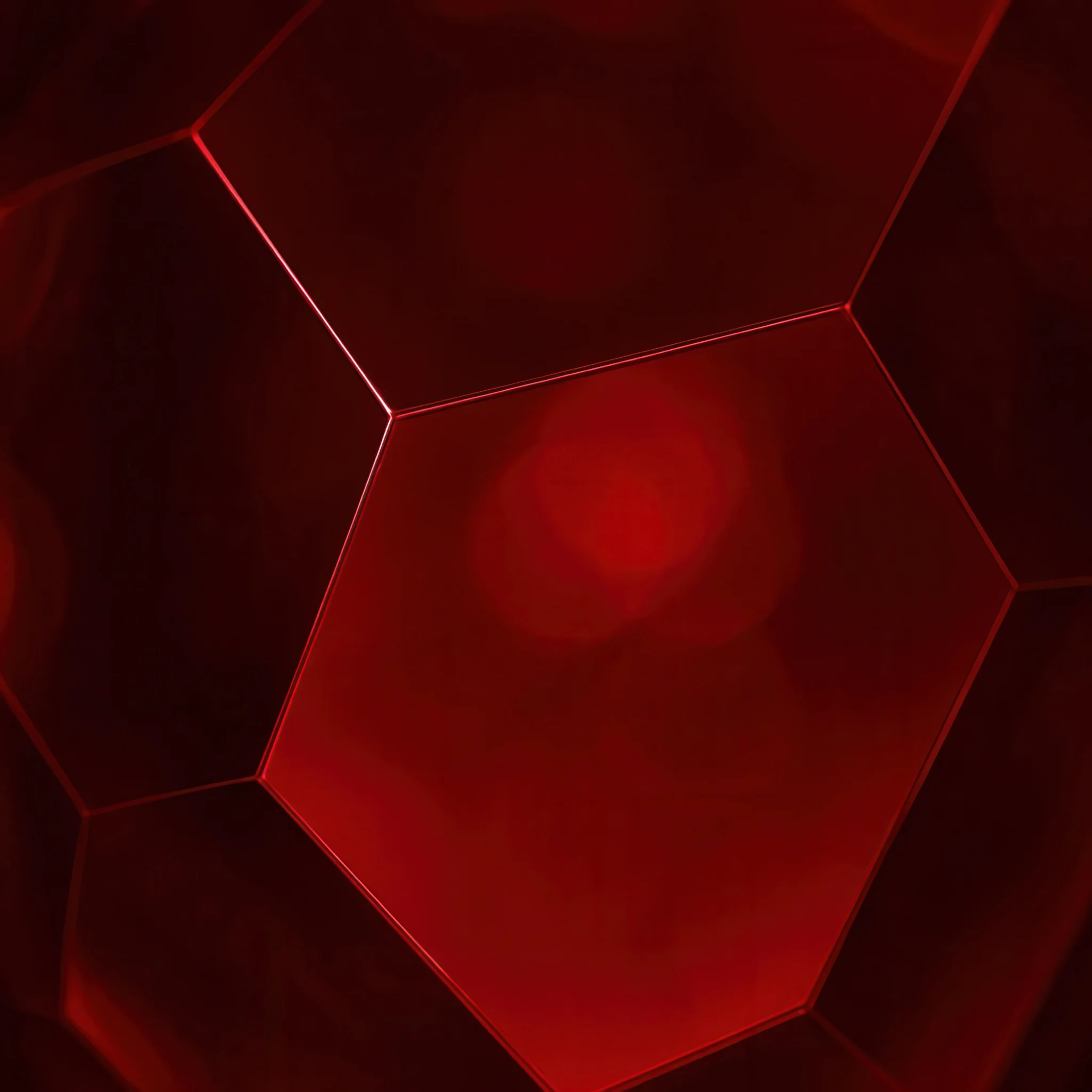 Close-up of a red inkjet printing background with hexagonal shapes, representing NUtec Digital Ink's ink series Ruby for digital printing.