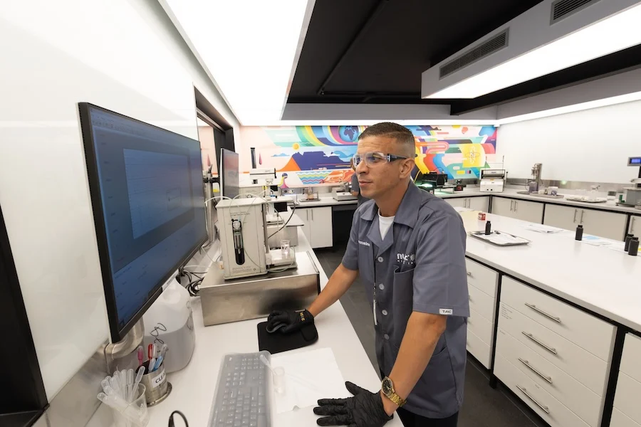 NUtec Digital Ink technician inspecting digital printing ink formulations in a modern laboratory